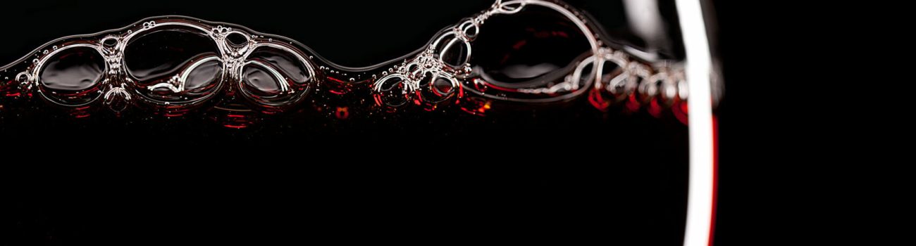 Red Wine Glass silhouette on Black Background with Bubbles